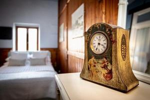 eine Uhr, die in einem Schlafzimmer auf einem Tisch sitzt in der Unterkunft La Chasse au Bonheur in Rieux-Minervois