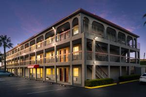 a building with a parking lot in front of it at Red Roof Inn Stockton in Stockton