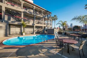 a swimming pool with tables and chairs next to a building at Red Roof Inn Stockton in Stockton