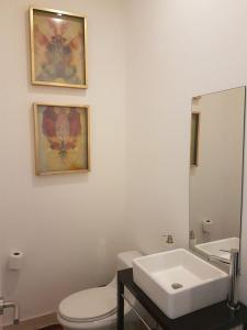 ein Badezimmer mit einem weißen WC und einem Waschbecken in der Unterkunft Milán in Mexiko-Stadt