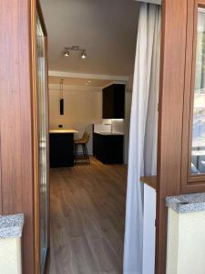 a view of a kitchen and a living room at Appartamento del rosengarten in Madonna di Campiglio