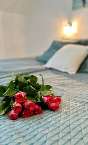 a bouquet of red roses on a bed at Ruda Sowa in Nowa Ruda