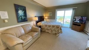 a living room with a couch and a bed at Buena Vista by the Sea in Qualicum Beach