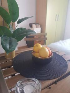 a bowl of fruit on a table with a plant at Budget Friendly in Požega