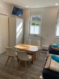 a room with a table and chairs and a bed at Haus Jörg in Lutter