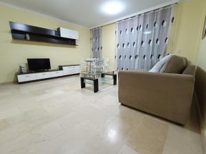 ein Wohnzimmer mit Sofa und Fernseher in der Unterkunft NG LA SALLE - Santa Cruz de Tenerife in Santa Cruz de Tenerife