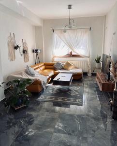 a living room with a couch and a table at Pensiunea Berg Hill in Băile Olăneşti +70 photos