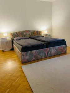 a bed sitting in a room with a rug at RELAX APPARTEMENT - Graz in Graz