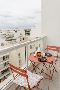 a red table and two chairs on a balcony at Stunning 1BDR Sliema-Center Penthouse! Near POOL! in Sliema