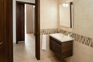 a bathroom with a sink and a mirror at Stunning 1BDR Sliema-Center Penthouse! Near POOL! in Sliema +30 photos