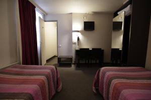 Postel nebo postele na pokoji v ubytování Hôtel Au Petit Caporal