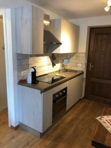 a small kitchen with a sink and a stove at appartamento valtournenche il nido in Valtournenche