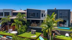 an aerial view of a house with a swimming pool at Executive, modern waterfront house in Maroochydore