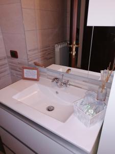 a white sink in a bathroom with a mirror at La Casa del Borgo-intero appartamento-cir22158 in Latina