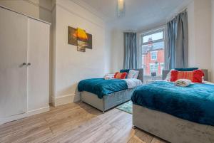a bedroom with two beds and a window at Stylish & Cosy in Coventry Garden Parking in Coventry
