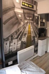 a room with a wall mural of a subway train at Quaint Studio Flat in the Heart of London in London