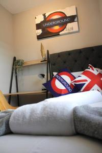 a bedroom with a bed with a bedspread and pillows at Quaint Studio Flat in the Heart of London in London
