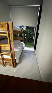 a small room with a bunk bed and a window at ¡Quinta al Cielo! in Girardot