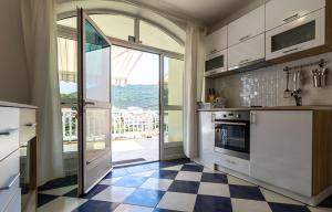 a kitchen with a checkered floor and a large window at Villa Tiha luka in Neum