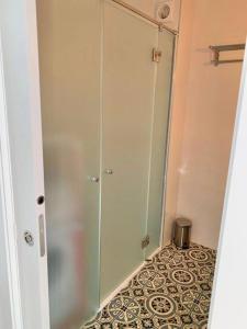 a glass shower stall in a bathroom with a tile floor at Fancy Studio Direct Access to Sea✺Parking✺Pool in Mijas
