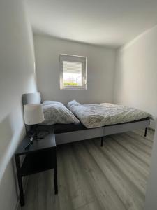 ein Schlafzimmer mit einem Bett und einem Tisch mit einer Lampe in der Unterkunft Paradiseresidency in Zagreb