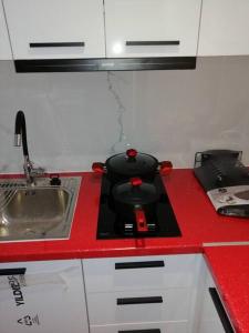 a black pot on a stove in a kitchen at Rafina's blue heart! in Rafina