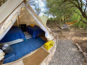 an overhead view of a tent with a bed and a hammock at CaminAndes Hostal in San Pedro de Atacama