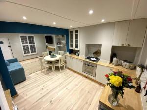 a large kitchen with a table and a counter top at The Lost Lobster - 2 bedroom cottage with parking in Kent