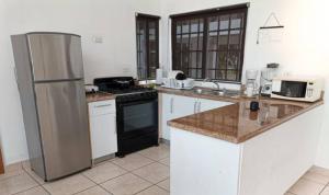 uma cozinha com um frigorífico e um fogão forno superior em Hermosa Casa de Playa em Nueva Gorgona