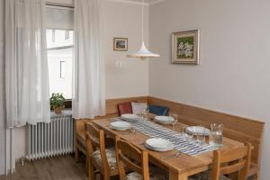 a dining room with a table with chairs and a table at Apartma Ajda in Železniki