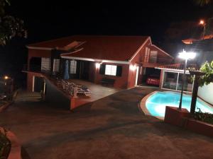 a house with a swimming pool at night at 2 bedrooms apartement with sea view private pool and enclosed garden at Lombo Do Doutor 1 km away from the beach in Calheta