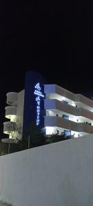 a building with a sign on it at night at Aquarius Hotel Boutique in Pampatar