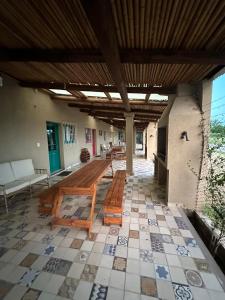 a patio with a table and benches on a tile floor at Cabañas Peumayén Salta in San Agustín