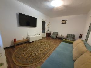 a living room with a couch and a flat screen tv at ZSE Residence in Constanţa