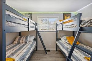 two bunk beds in a room with a window at Pet-Friendly Large-Group Oasis in Bay City