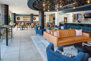 a lobby with a couch and chairs and a bar at Hotel Indigo Austin Downtown, an IHG Hotel in Austin
