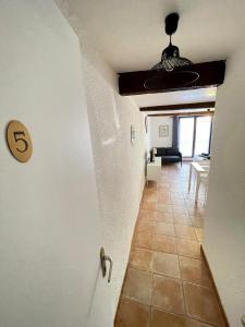 a hallway with a door to a living room at Virée à deux in Riez