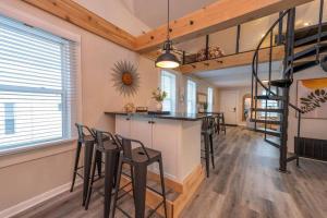 a kitchen and dining room with a bar and stools at Family Beach Retreat w/Fun Loft Space, Firepit in Michigan City