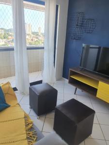 a living room with a tv and a couch at Apartamentos Natal in Natal