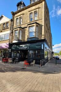 a building with a coffee shop on a city street at Contemporary 1 Bed Apartment, In Central Buxton in Buxton