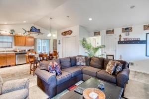 a living room with a couch and a kitchen at Rockaway Retreat - Meredith Lodging in Rockaway Beach