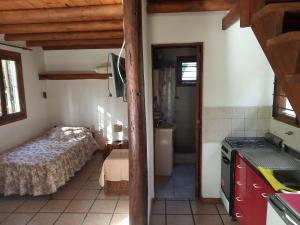 a small room with a bed and a bathroom at Bosque & Mar in Mar del Plata
