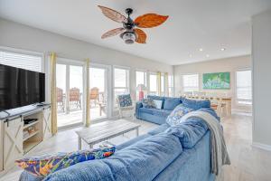a living room with a blue couch and a tv at Seashore's Best in North Topsail Beach