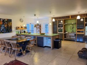 a large kitchen with a table and some chairs at New Forest Cottage alongside Limewood Lyndhurst in Lyndhurst