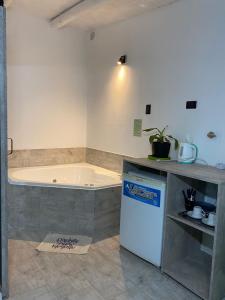 a kitchen with a bath tub in a room at Sierras Alojamiento in Mina Clavero