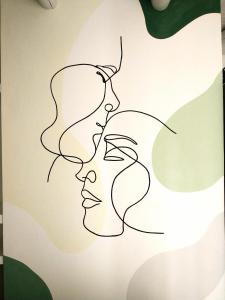 a continuous line drawing of three faces at Sierras Alojamiento in Mina Clavero