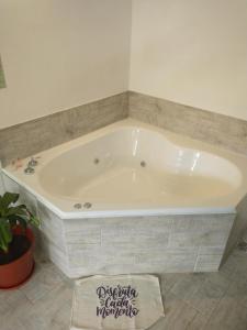 a large white bath tub in a bathroom at Sierras Alojamiento in Mina Clavero