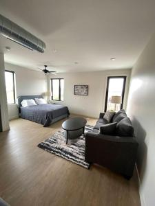 a large living room with a bed and a couch at River Front Luxury Furnished Studio Downtown QC in Davenport