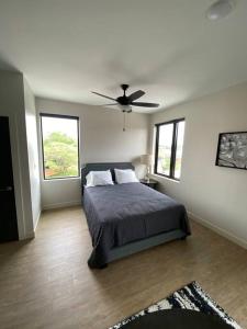 a bedroom with a bed and a ceiling fan at River Front Luxury Furnished Studio Downtown QC in Davenport