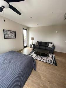 a bedroom with a bed and a couch at River Front Luxury Furnished Studio Downtown QC in Davenport